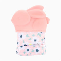 Teething mitt in the shape of a pink bunny, featuring a floral fabric and attached tag, designed for babies.