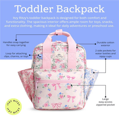 Toddler backpack by Itzy Ritzy in floral design with pink straps, features side pockets, a front zippered pocket, and a clip loop.