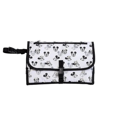 Portable diaper changing station in ivory featuring a Mickey and Minnie Mouse pattern, secured with a black strap and buckle.