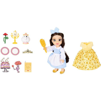 Disney Petite Doll of Belle holding a yellow brush, with a golden dress, accessories including a rose, candelabra, and notebook.
