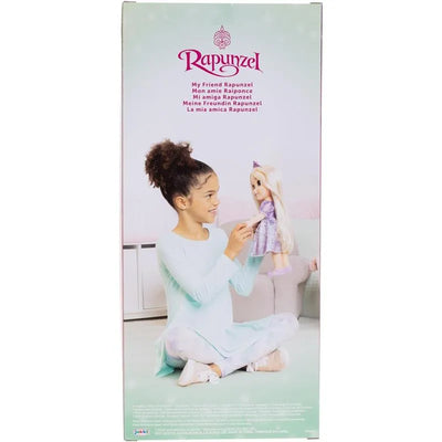 A child with curly hair holds the Jakks Rapunzel doll, dressed in a purple gown, sitting in a living room.