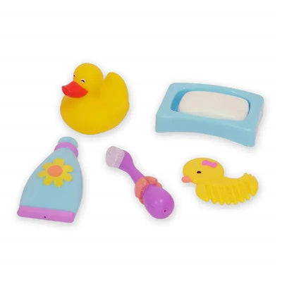 Five colorful bath toys including a rubber duck, a soap bar, a bottle, a toothbrush, and a small yellow duck comb.