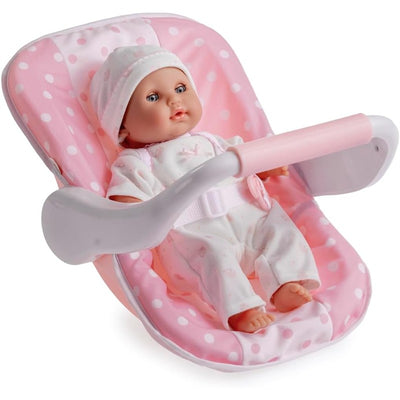 Soft body baby doll dressed in a pink polka dot outfit, seated in a matching baby bouncer with a safety harness.