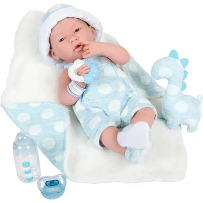 Anatomically correct vinyl baby doll dressed in a blue outfit with white dots, holding a teether, with a bottle and plush dinosaur.