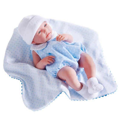 17-inch all-vinyl baby doll dressed in a blue polka dot outfit with a white hat, lying on a matching blanket.