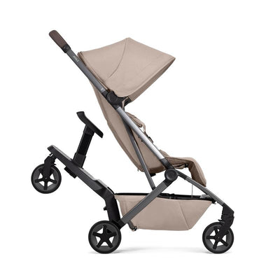 Joolz Aer² footboard with seat featuring a beige stroller, adjustable hood, and ergonomic handle.