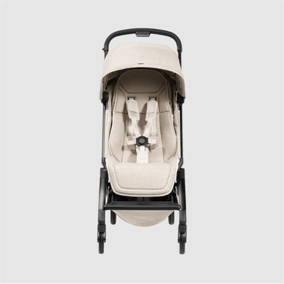 Lightweight compact Joolz Aer² stroller in calming beige, showing an ergonomic seat with harness and sun canopy.
