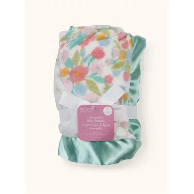 Reversible baby blanket by Jujube featuring a floral pattern in pastel colors and a satin-like turquoise border.