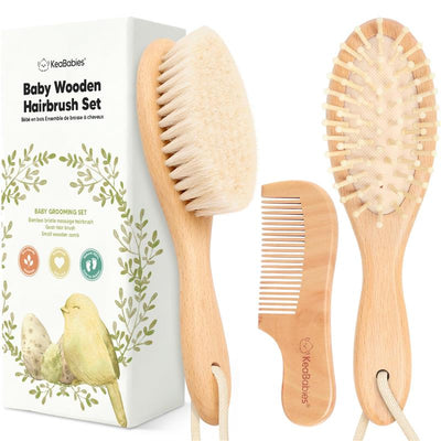 Hair brush and comb set for babies, featuring a soft-bristled brush and a wooden comb, packaged in a decorative box.