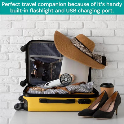 Gray/chrome Kidco 3 Speed Turbofan inside an open yellow suitcase filled with travel essentials like a hat, sunglasses, and shoes.