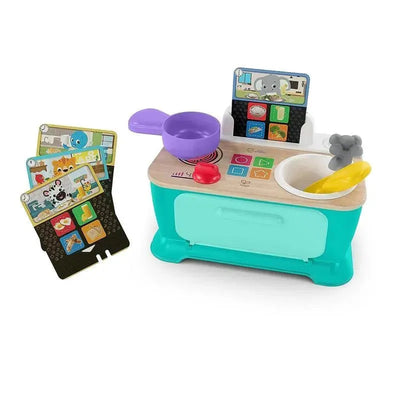 Kids II - Be + Hape Magic Touch Kitchen toy with interactive cooking features, utensils, and colorful recipe cards.