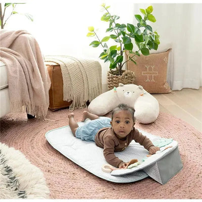 Cozy Prop 4-in-1 Sit Up & Prop Activity Mat featuring a baby playing on a soft mat with colorful toys around.