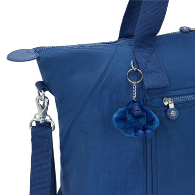 Kipling New Art M Baby Bag in Casual Blue with a furry blue keychain monkey and multiple zippered pockets.