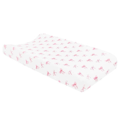 Change pad cover featuring a white background adorned with pink bow patterns, designed for infant changing tables.