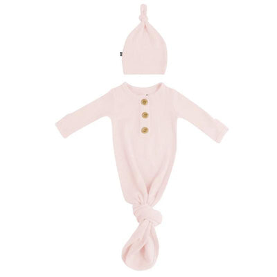 Ribbed blush gown with three buttons at the neck and a matching knotted hat, designed for infants.