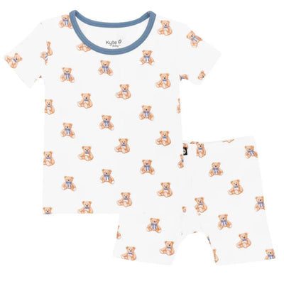 Short sleeve pajamas for kids featuring a teddy bear print, made from soft fabric with a blue trim.