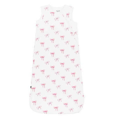 Kyte Baby Sleep Bag in Bow 1.0 Tog, featuring a white fabric with a pattern of pink bows.