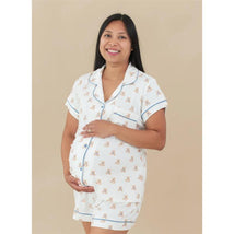 Kyte Baby Women’s Short Sleeve Pajama Set in Teddy Bear print, featuring a pregnant model smiling and holding her belly.