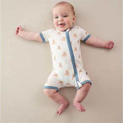 Zippered shortall romper in teddy bear print on a baby, featuring short sleeves and a front zipper.
