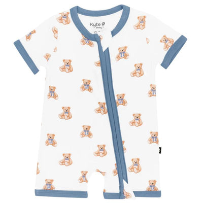 Zippered shortall romper by Kyte Baby, featuring a teddy bear print on a white background with blue trim.