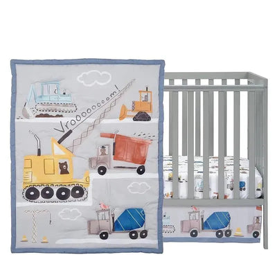 Three-piece crib bedding set featuring construction vehicles on a quilt, paired with a matching crib sheet, ideal for a nursery.