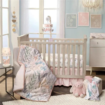 3Pk Baby Blooms pink floral and butterfly crib bedding set displayed in a nursery with a beige crib, blanket, and soft toys.