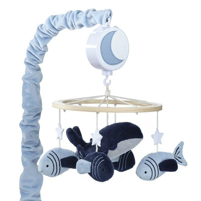 Musical mobile featuring plush whales and fish, suspended from a light wood frame with stars, ideal for nursery decor.