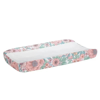 Changing pad cover featuring a colorful floral pattern in pastel hues, designed for baby care.