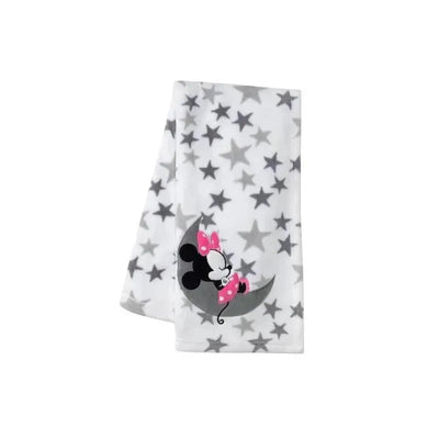 White blanket featuring gray stars and an illustration of Mickey Mouse on a crescent moon with a pink bow.