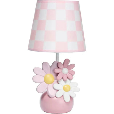 Lambs & Ivy Daisy Dreams lamp features a pink and white checkered shade and a base with colorful daisy flower accents.