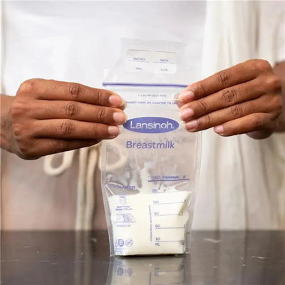 Lansinoh breastmilk storage bag held by a person, showcasing clear measurement markings and instructions for use.