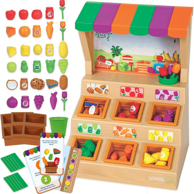 Colorful Learning Resources Mini Farmstand Sorting Set featuring fruits, vegetables, and play items in wooden bins, promoting sorting skills.