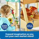 Child playing at a toy farm stand, showcasing flowers and storage compartments for pretend play.