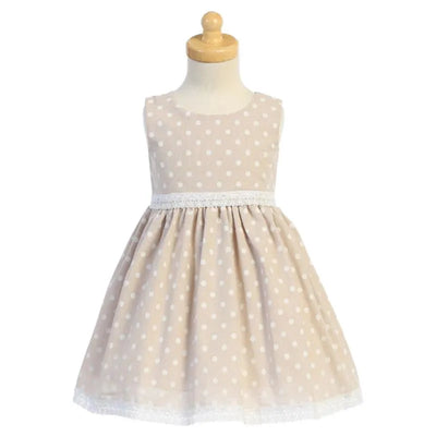 Beige cotton chambray dress for baby girls, featuring white polka dots and a lace trim at the hem and waist.