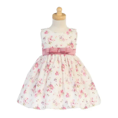 Cotton floral print dress for baby girls, featuring pink roses and a matching pink bow at the waist.