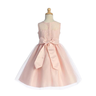 Light pink baby girl dress featuring lace top, back button closure, and a satin bow at the waist, complemented by a tulle skirt.