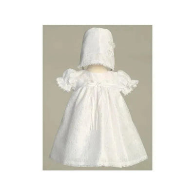 White short dress for baby girl featuring a lace yoke and puff sleeves, accompanied by a matching bonnet.