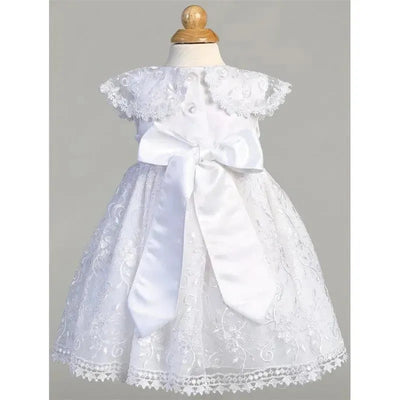 Embroidered white tulle dress for baby girls, featuring a lace collar and a large satin bow at the waist.