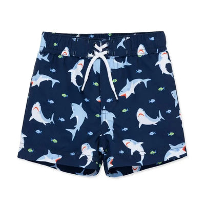 Blue swim trunks for baby boys featuring a playful shark pattern with small fish accents and a white drawstring.