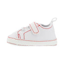 Little Me Baby Boy Sneaker in white canvas with red stitching and Velcro strap.