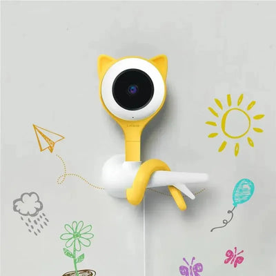 Lollipop camera with tangerine tabby design, mounted on a wall, surrounded by colorful doodles.
