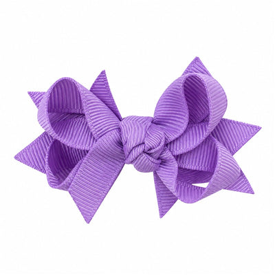 A purple hair bow featuring multiple loops and tails, designed as a decorative accessory for children.