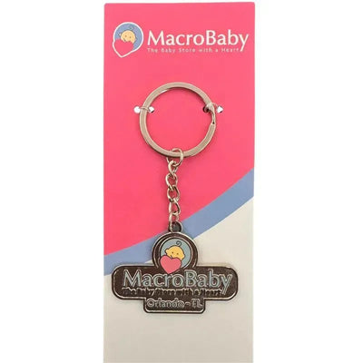 Metal keychain featuring the Macrobaby logo with a heart and a chick, attached to a promotional card.