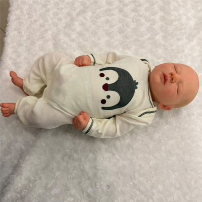 Macrobaby Reborn Doll, Jaxson Asleep 2, features white vinyl, painted hair, closed eyes, and a penguin-themed outfit.