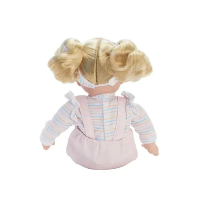Doll with blonde pigtails wearing pastel-striped shirt and pink overalls, showcasing the back view of the outfit.
