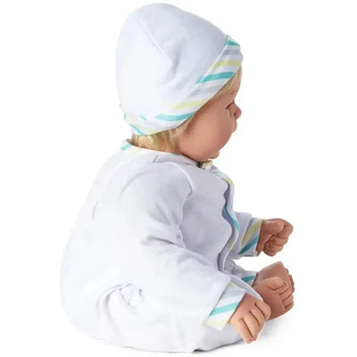 Madame Alexander doll with light skin tone, blue eyes, and blonde hair, wearing a white outfit and hat.