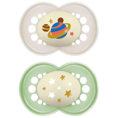 Two MamOriginal Night Pacifiers for ages 6-16 months: one cream with planet designs, the other green with star motifs.