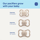 Three Mam Supreme pacifiers for different age stages: 0-6 months, 6-16 months, and 16+ months. Each features a premium extra thin nipple.