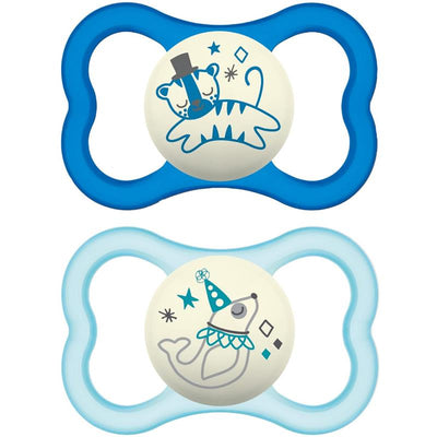 Two Mam air night pacifiers for boys, featuring a blue tiger design and a light blue whale design, suitable for ages 16 months and up.