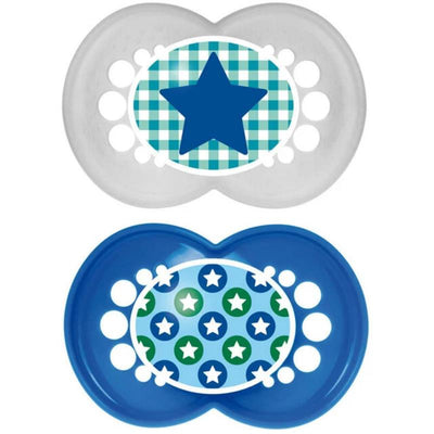Two silicone pacifiers for infants, one clear with a blue star design on a checkered background, and one blue with a pattern of stars and circles.